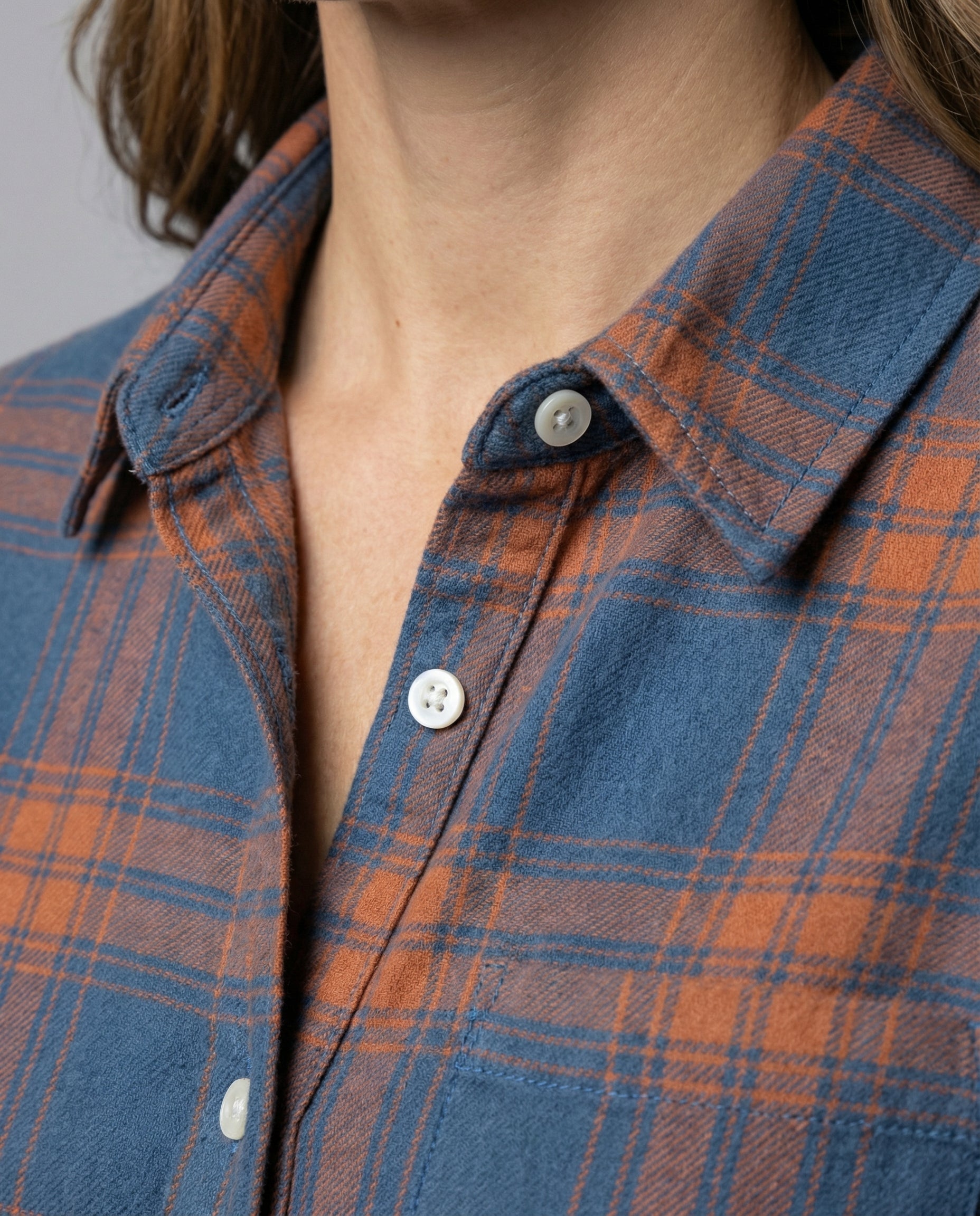 checkered shirt blouse with long sleeves, button front closure, and classic collar.