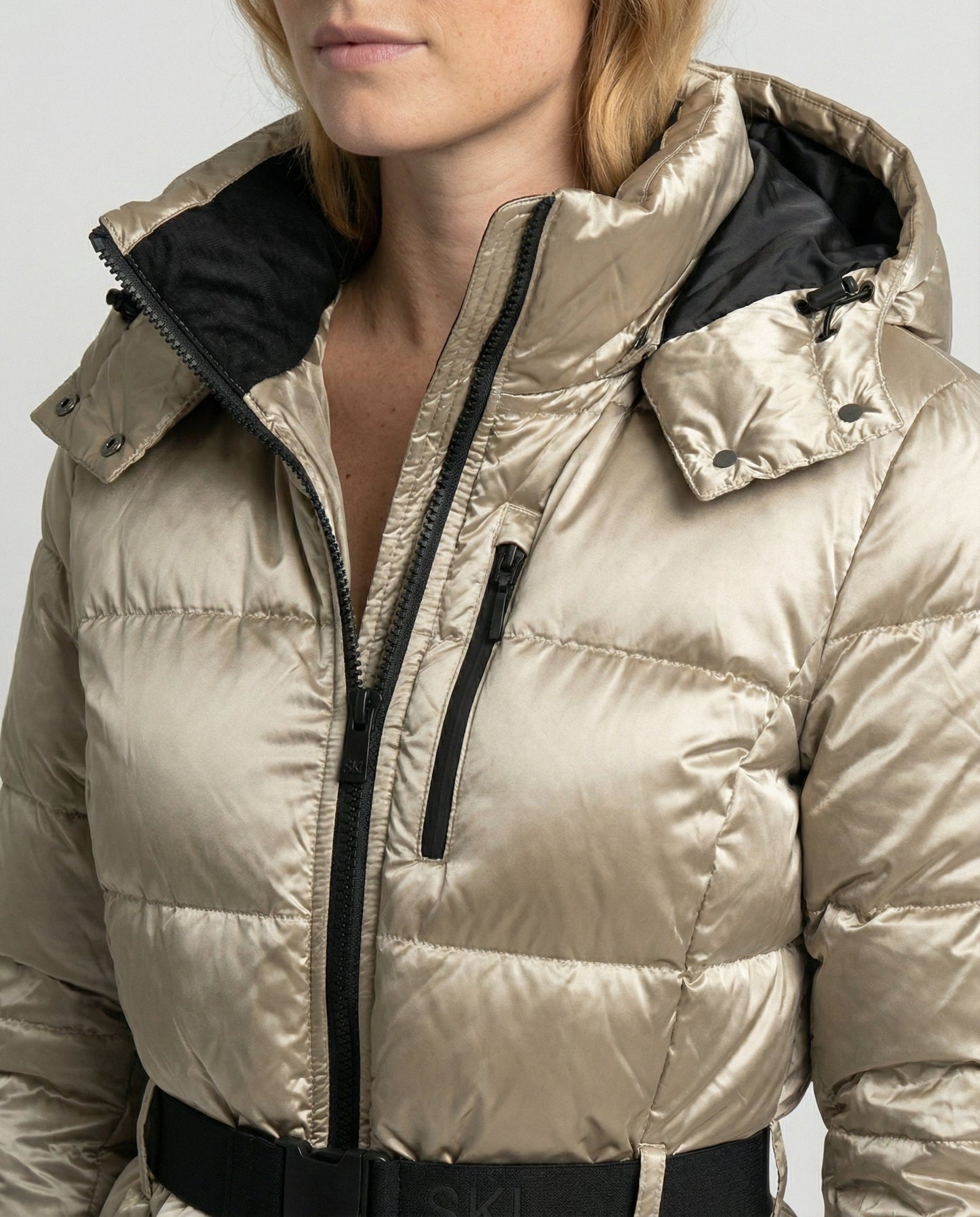 quilted ski jacket with insulated design, hood, and belted waist
